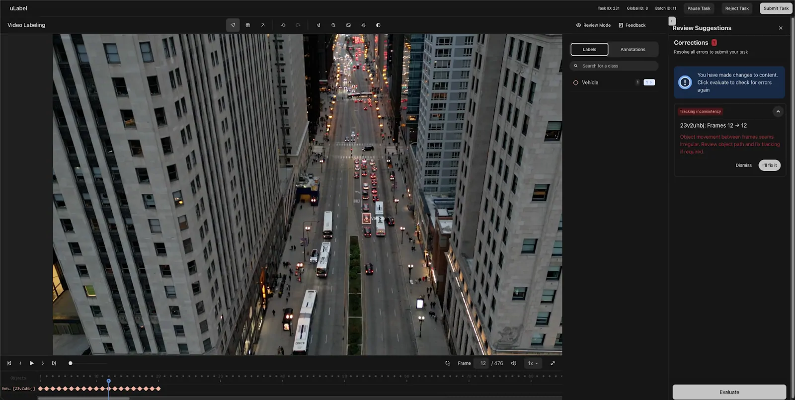 Aerial view of a busy city street lined with tall buildings, featuring multiple buses, cars, and pedestrians on sidewalks during dusk. The scene is displayed within a video labeling software interface, with annotation and review suggestion panels visible on the right side of the screen.